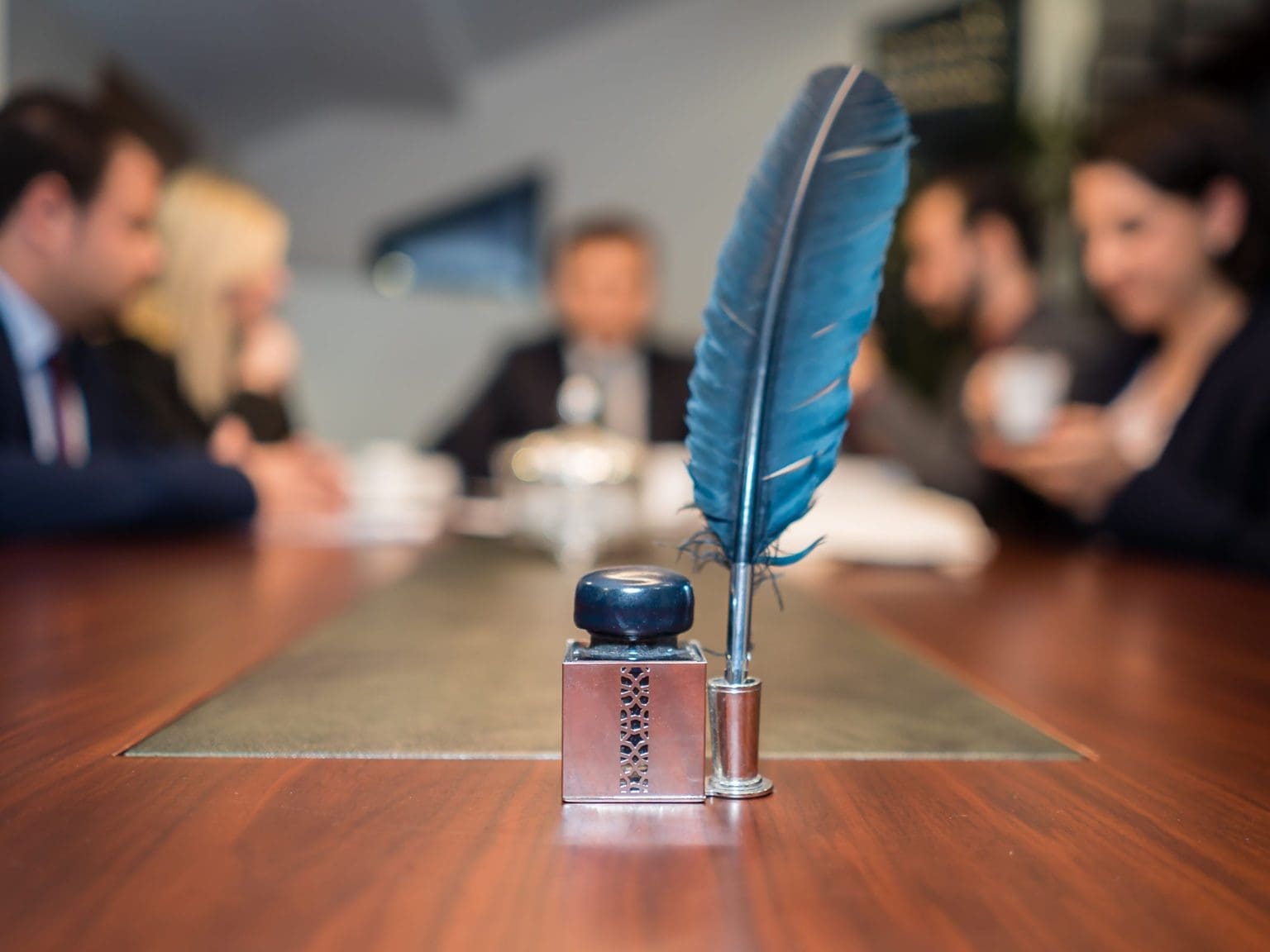 Meeting in a room with a feather in front.