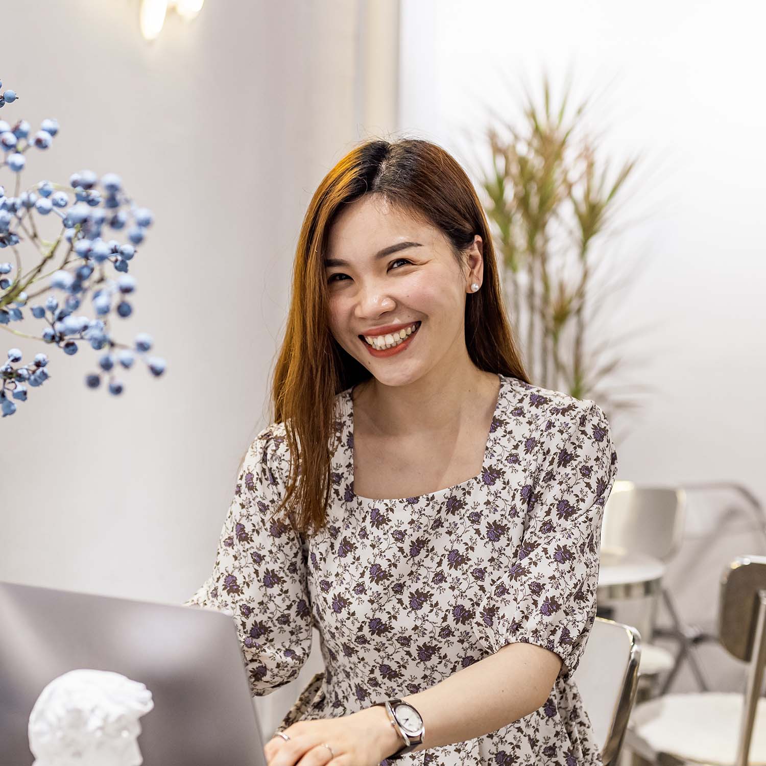 Woman smiling while working on computer.