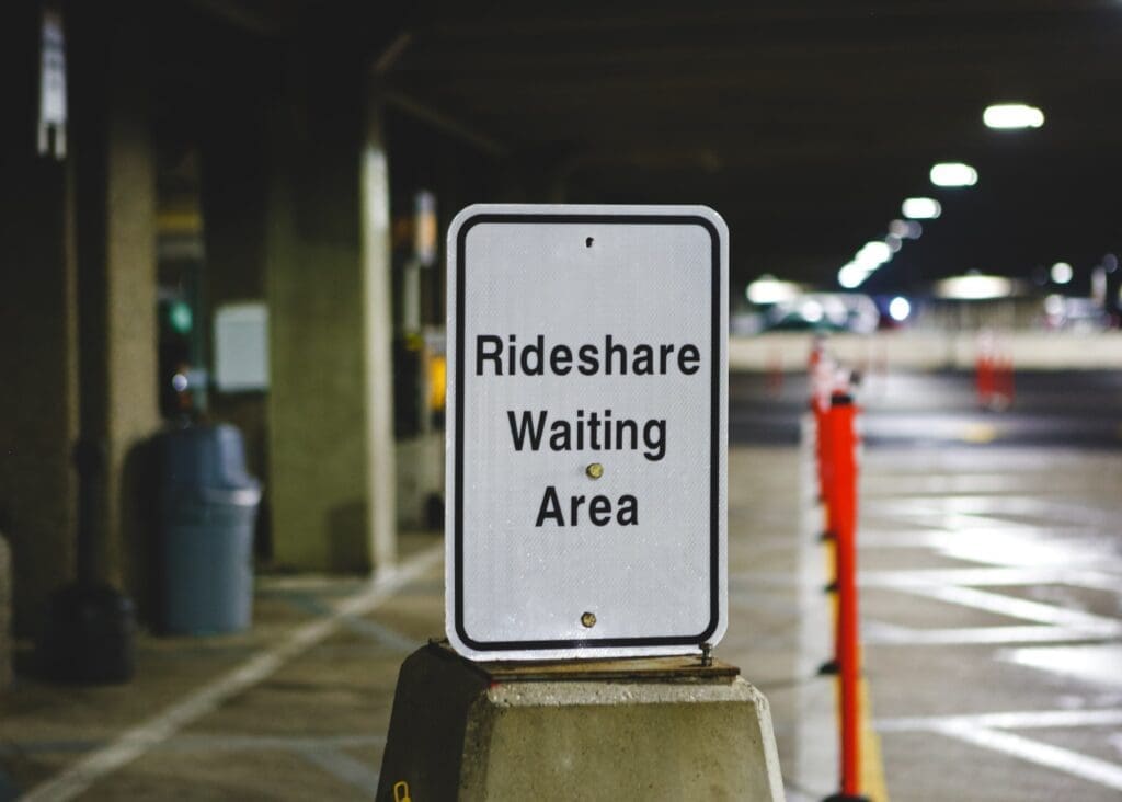 Sign indicating 'Rideshare Waiting Area' at the airport, underscoring the ubiquity and integration of rideshare services in modern transportation hubs amidst ongoing uber sexual assault litigation.