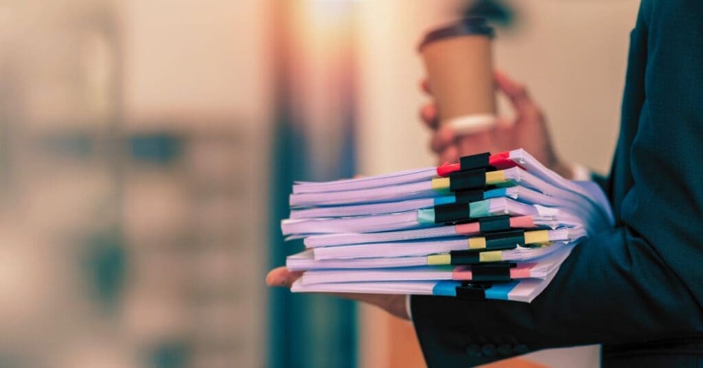 Stack of legal documents and case files representing multidistrict litigation (MDL) process