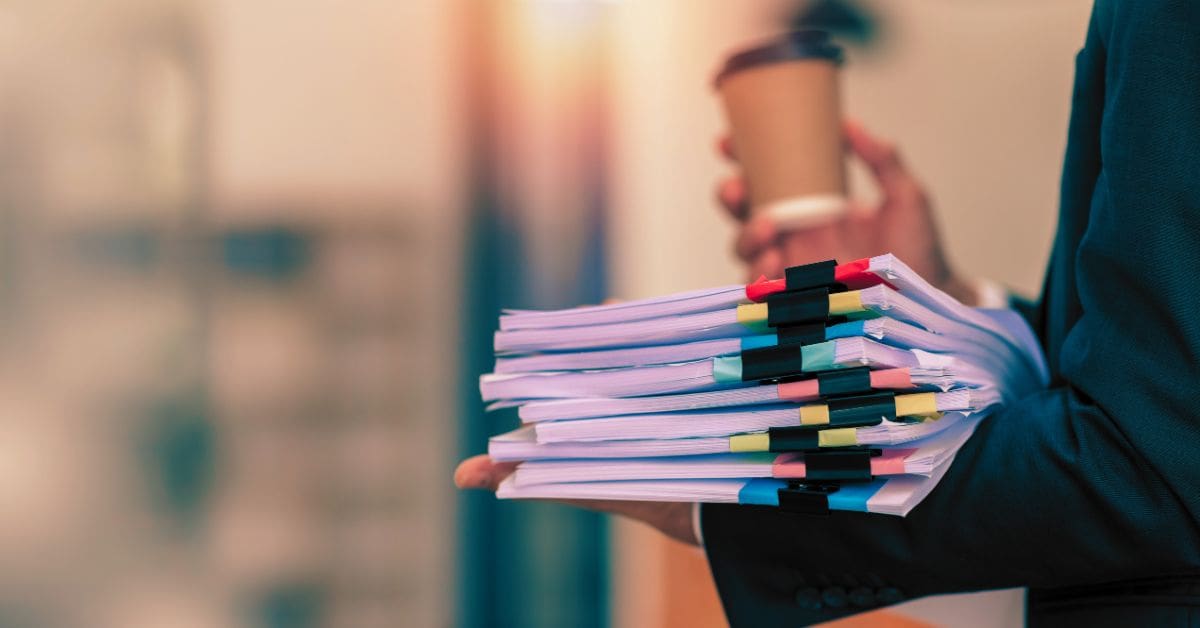 Stack of legal documents and case files representing multidistrict litigation (MDL) process