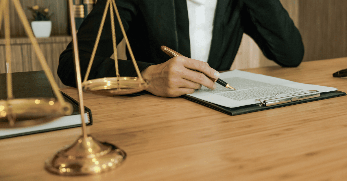 Lawyer discussing lawsuit settlement value with client, legal documents and scales of justice in view