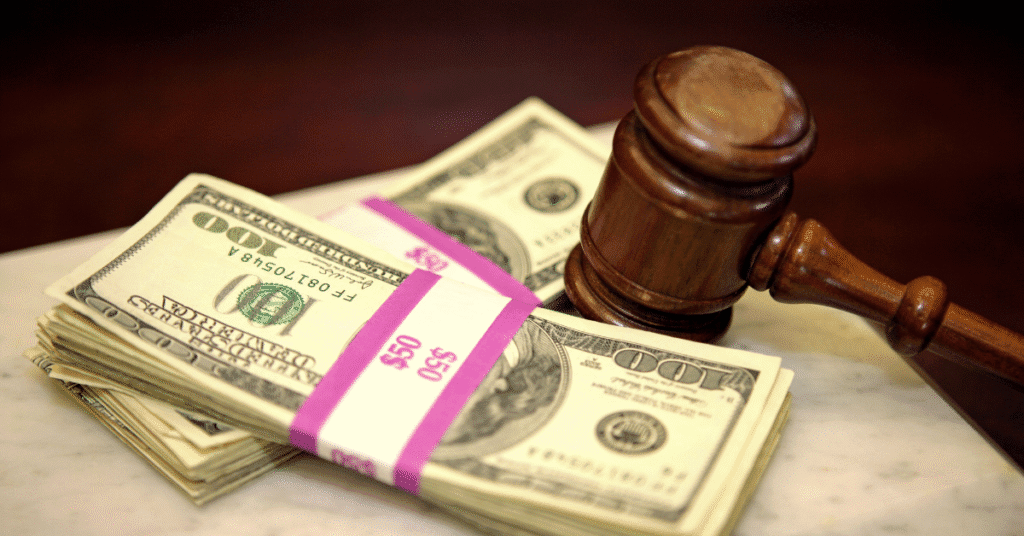 Legal settlement documents, tax forms, and gavel representing taxable and non-taxable lawsuit payments