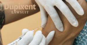 Dupixent lawsuit cover image showing injection with syringe into patient’s arm, representing legal cases over side effects