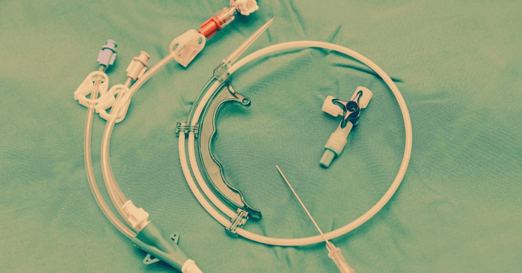Medical port catheter assembly and tubing on a surgical drape, representing the devices involved in the AngioDynamics SmartPort, Vortex, and Xcela lawsuits.
