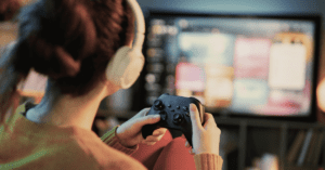 A young teenager staring intensely at a glowing monitor in a dark room, with a digital "overlay" of a slot machine and dopamine molecule, representing the science of gaming addiction.