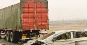 A professional view of a commercial semi-truck dashboard and an Electronic Logging Device (ELD), representing trucking litigation and federal compliance.