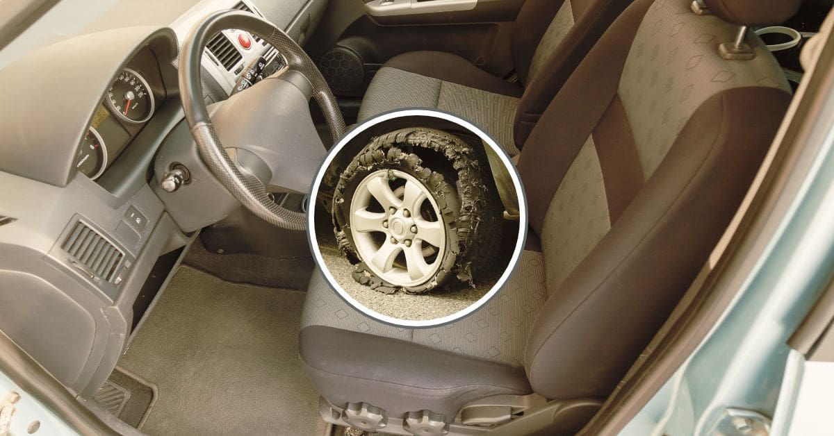 A close-up of a failed vehicle tire showing tread separation and exposed steel belts, indicating a manufacturing defect.
