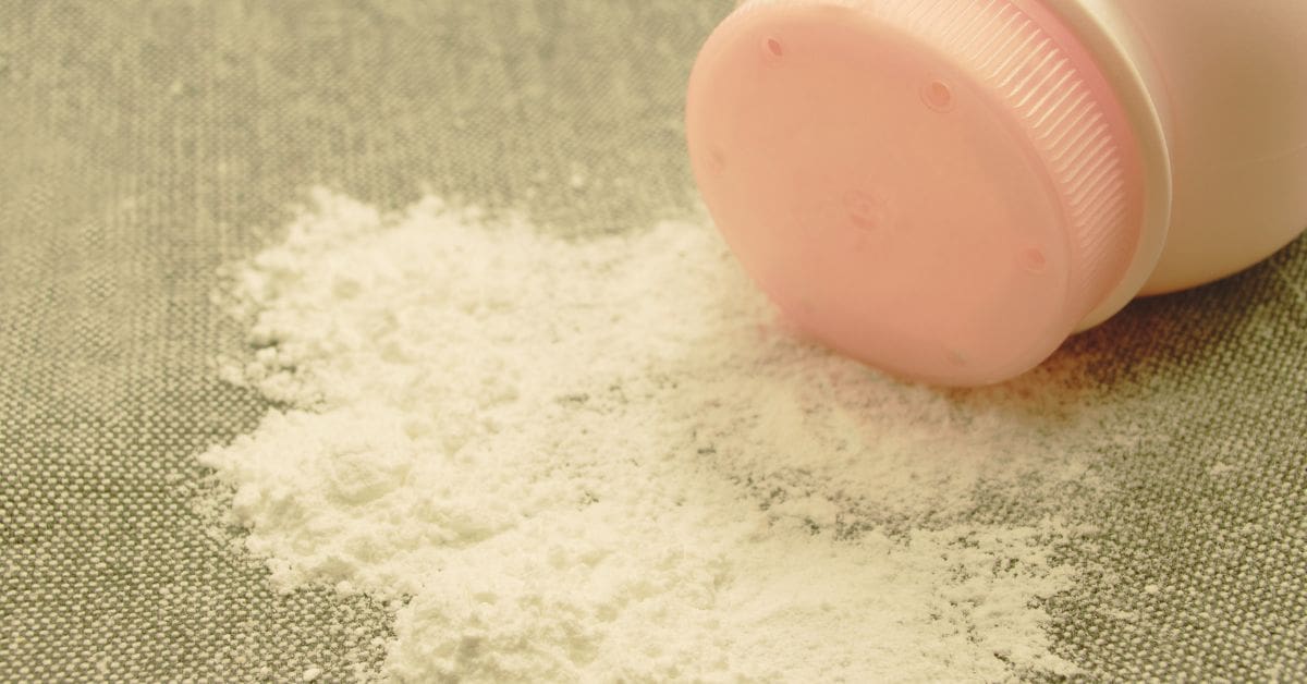 Woman applying baby powder creating a dust cloud that reveals hidden asbestos fibers, representing the talcum powder lawsuit for ovarian cancer and mesothelioma.